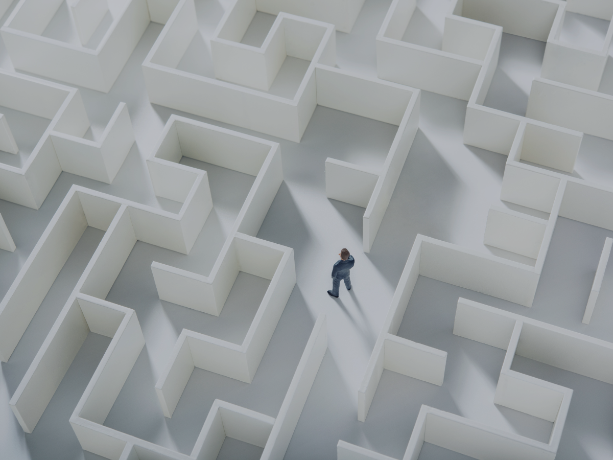 Business man stuck in white maze