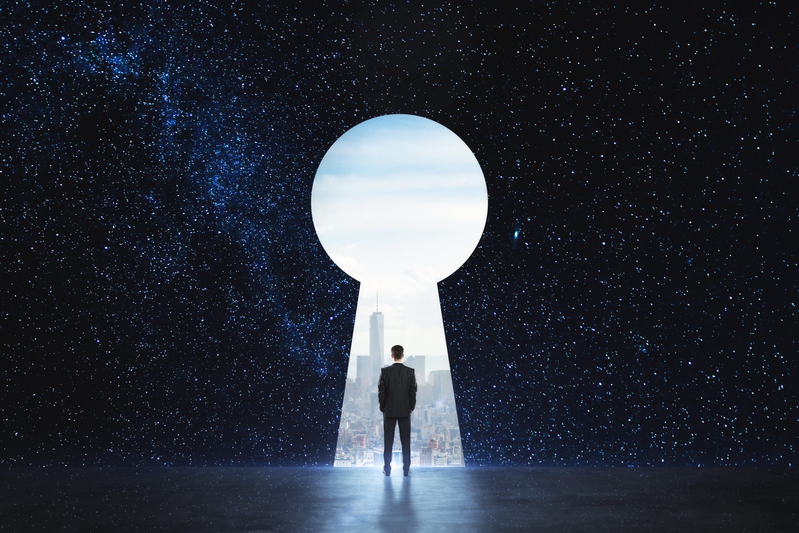 Back view of young businessman standing against keyhole door on starry sky background.