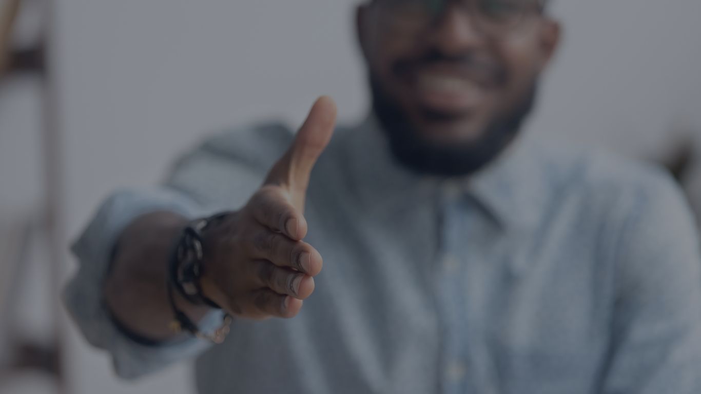 photo of a man reaching out to shake your hand