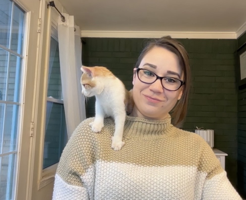 photo of Allison with her orange and white kitten named Nimbus