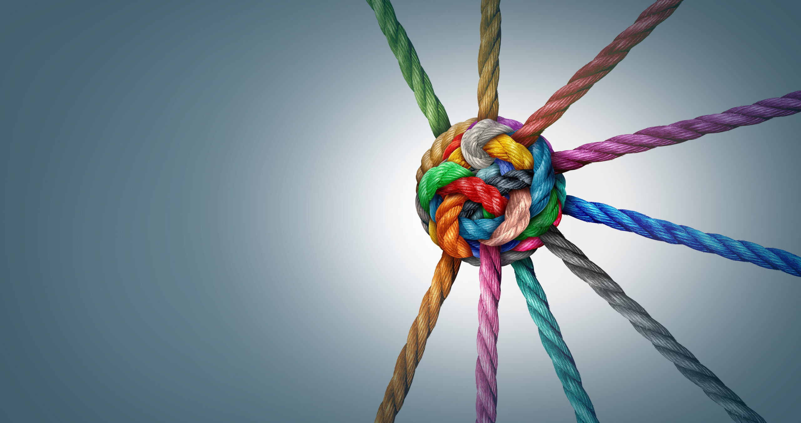 Collective Effort Integration and Unity with teamwork concept as a business metaphor for joining a partnership synergy and cohesion as diverse ropes connected together in interdependence.