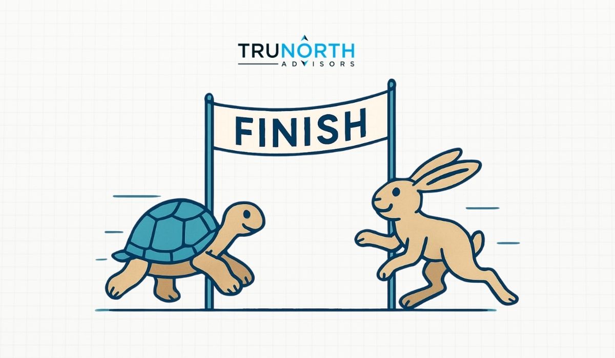 A cartoon turtle and rabbit, representing organic marketing and paid marketing, race toward a finish line with "FINISH" on the banner. At the top, the TRU NORTH ADVISORS logo appears in this playful nod to the classic tortoise and hare fable.